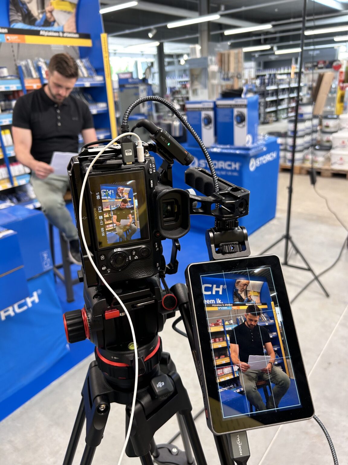 Camera on a tripod with monitor during a corporate shoot